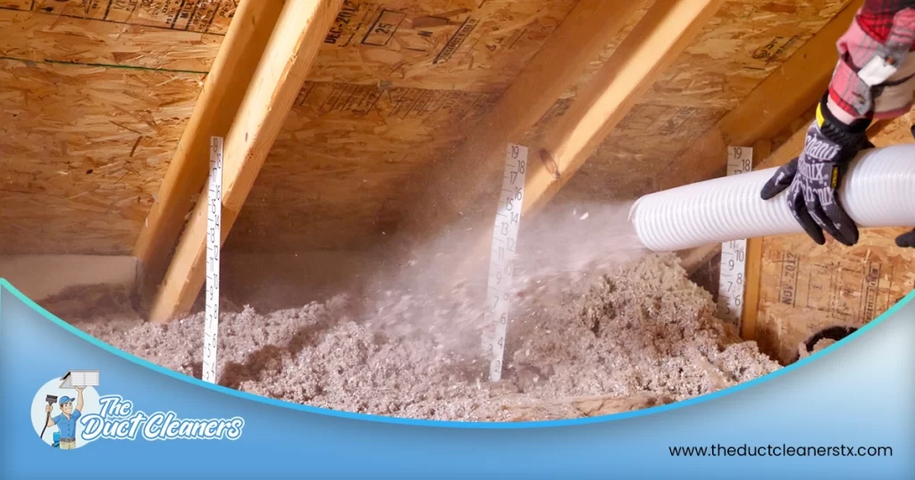 Shows an image where a technician is installing insulation in the attic.