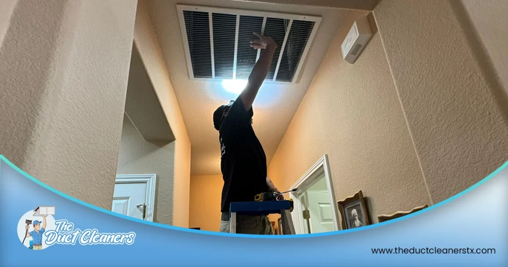 Shows an image of The Duct Cleaners' technician inspecting the air ducts.