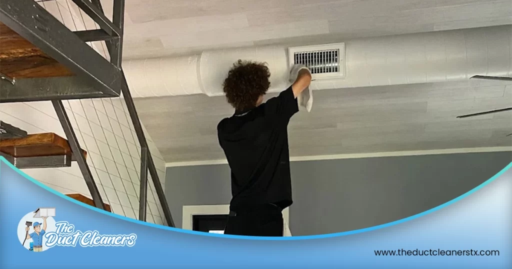 Shows an image where a technician can be seen cleaning the air ducts inside the customer's home.