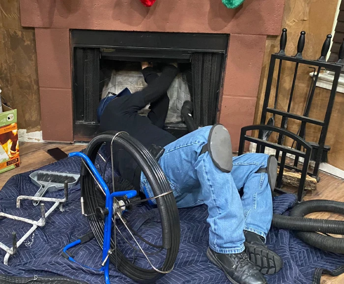 Our technician cleaning the chimney fireplace