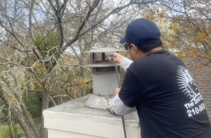 Technician cleaning chimney