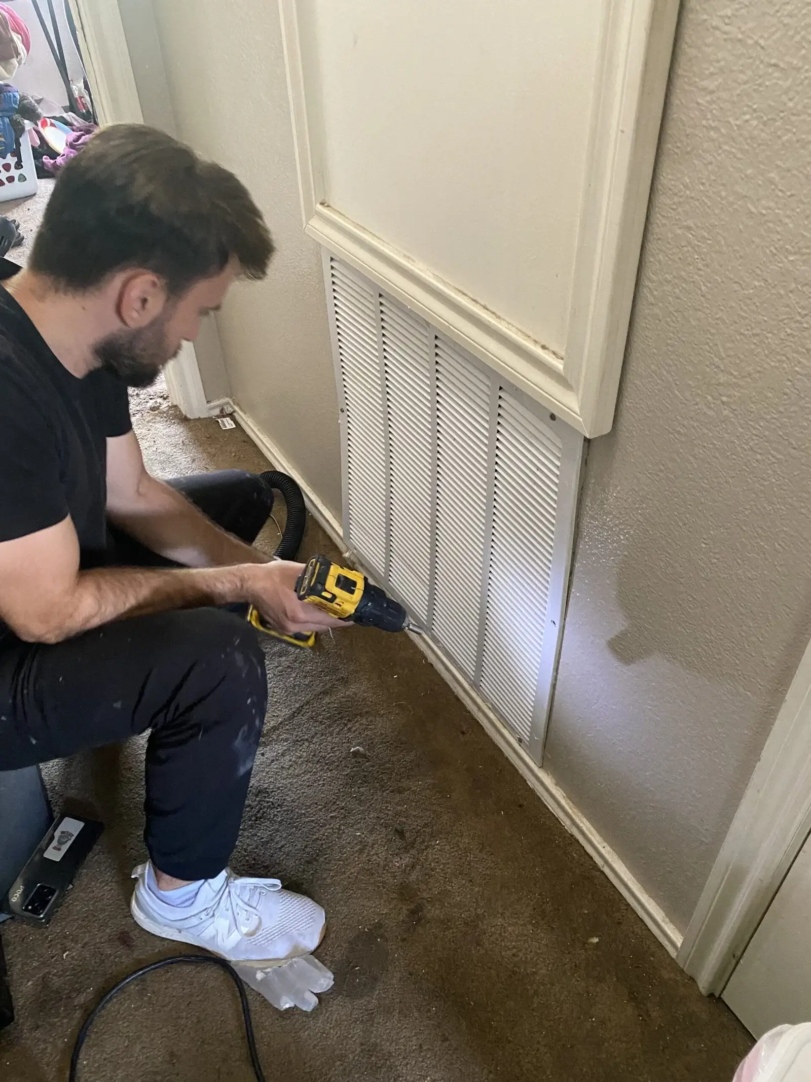 Professional technical opening the air duct cover to clean the air duct
