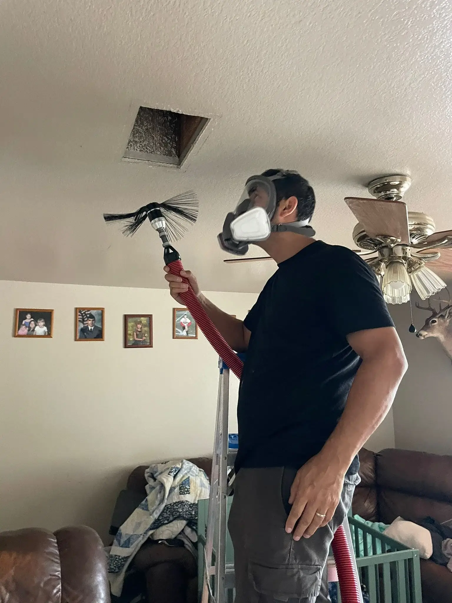 Technician cleaning air duct using rotobrush